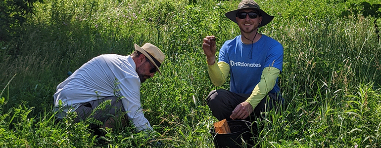 Photo of two guys collecting seeds